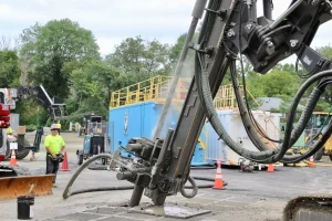 Crews drill a borehole to install networked geothermal, which heats and cools nearby homes using the ground as a battery. Eversource